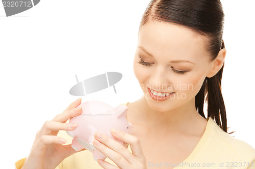 Image of  lovely woman with piggy bank	 