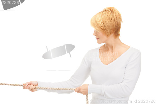 Image of business woman pulling rope