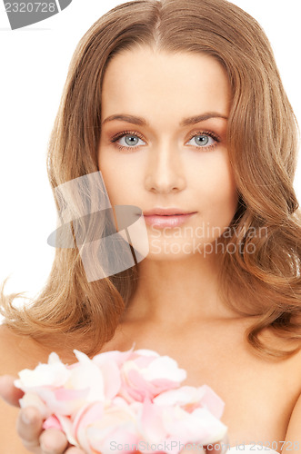 Image of beautiful woman with rose petals