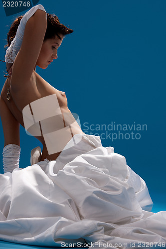 Image of beautiful topless bride over blue