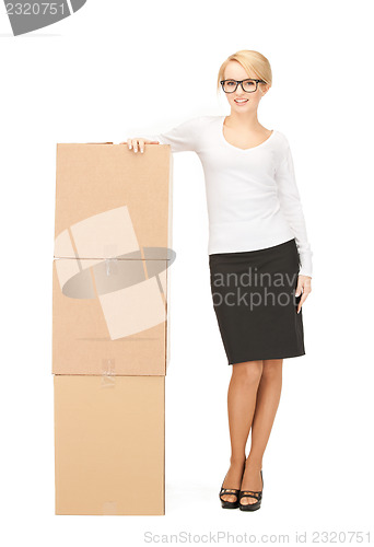 Image of  attractive businesswoman with big boxes	 