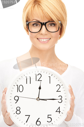 Image of woman holding big clock