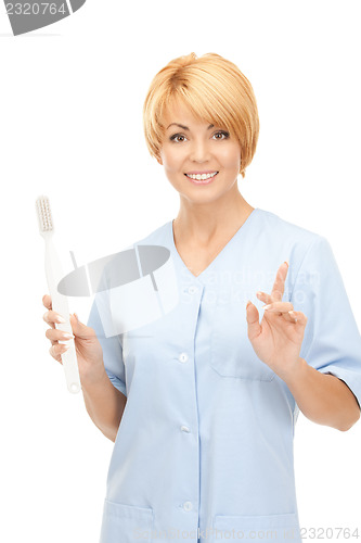 Image of doctor with toothbrush