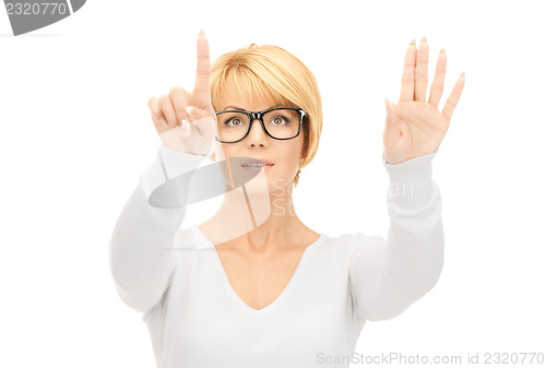 Image of businesswoman working with something imaginary 