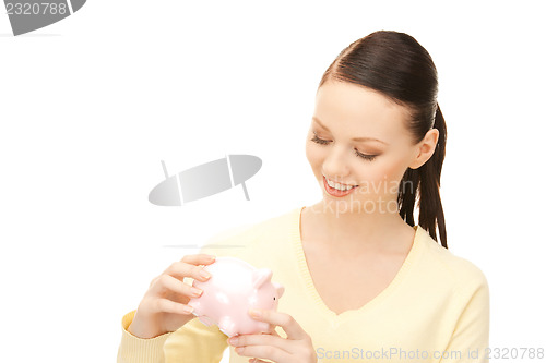 Image of  lovely woman with piggy bank	 