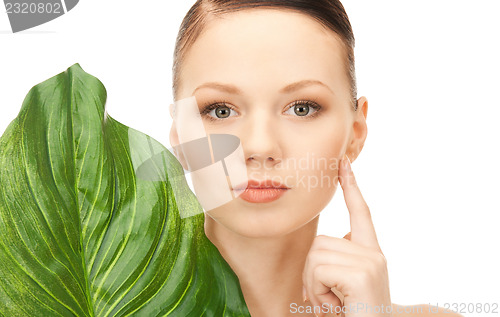 Image of woman with green leaf