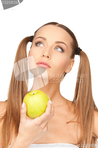 Image of young beautiful woman with green apple