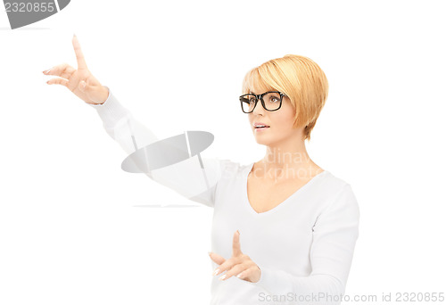 Image of businesswoman working with something imaginary 