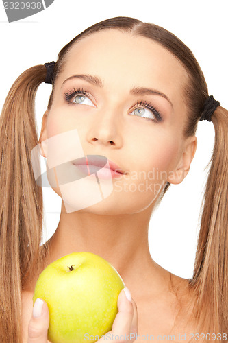 Image of young beautiful woman with green apple