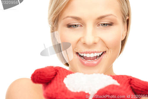 Image of beautiful woman in red mittens with snow