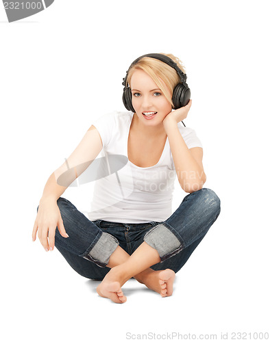 Image of  happy teenage girl in big headphones