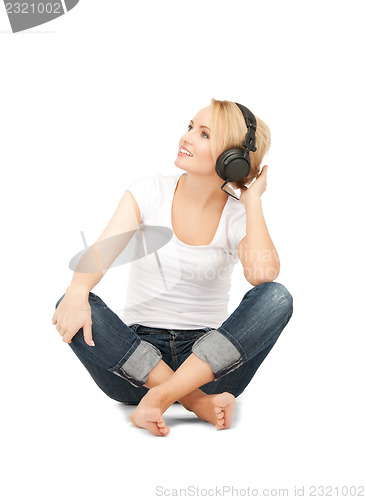 Image of  happy teenage girl in big headphones