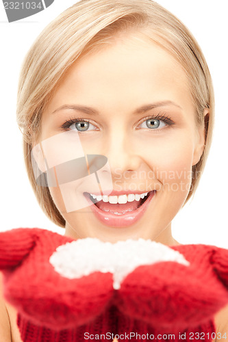 Image of beautiful woman in red mittens with snow