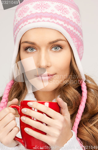 Image of beautiful woman with red mug