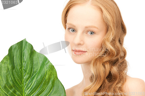 Image of woman with green leaf