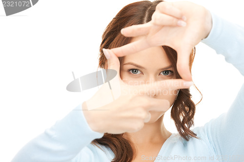 Image of lovely woman creating a frame with fingers