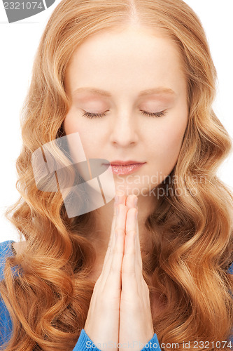 Image of praying businesswoman