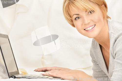 Image of happy woman with laptop computer