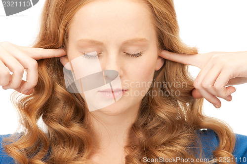 Image of woman with fingers in ears