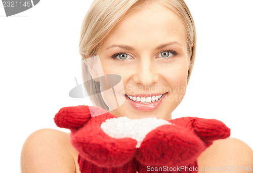 Image of beautiful woman in red mittens with snow