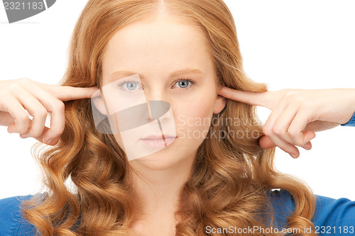 Image of woman with fingers in ears