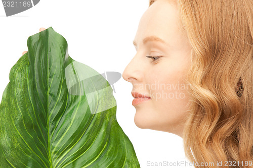 Image of woman with green leaf
