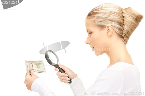 Image of woman with magnifying glass and money