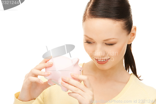 Image of  lovely woman with piggy bank	 