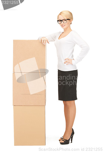 Image of  attractive businesswoman with big boxes	 