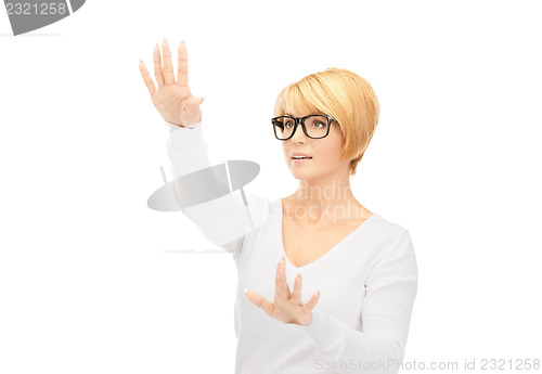 Image of businesswoman working with something imaginary 