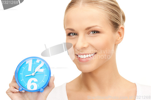 Image of woman holding alarm clock