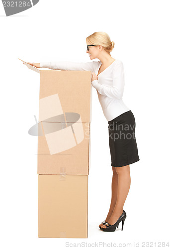 Image of  attractive businesswoman with big boxes	 