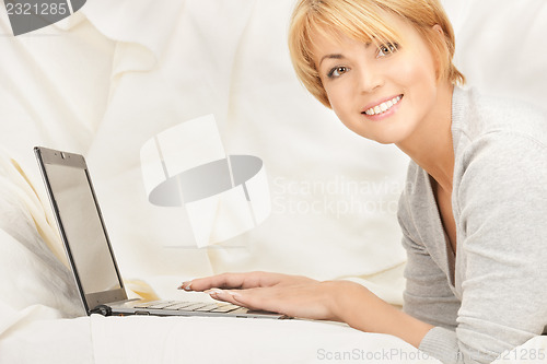 Image of happy woman with laptop computer