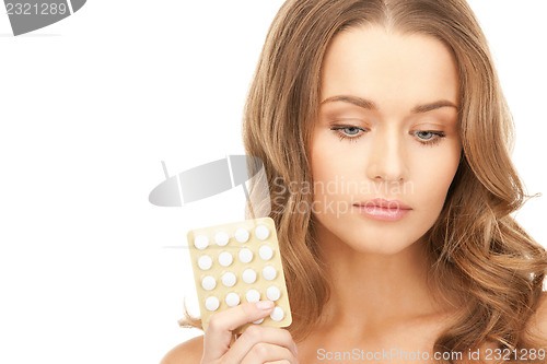 Image of young beautiful woman with pills 