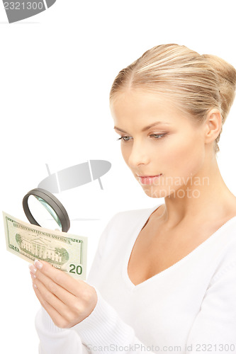 Image of woman with magnifying glass and money