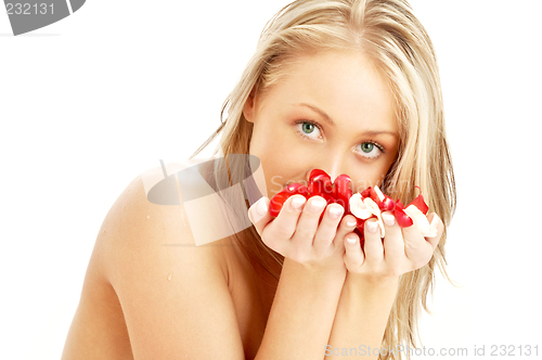 Image of lovely blond in spa with red and white rose petals