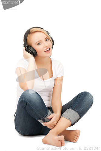 Image of  happy teenage girl in big headphones