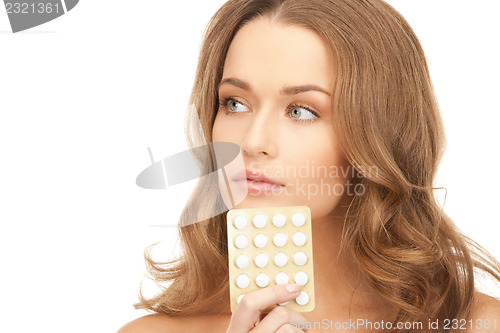 Image of young beautiful woman with pills 