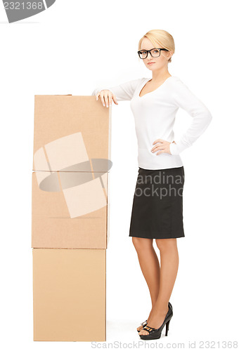 Image of  attractive businesswoman with big boxes	 