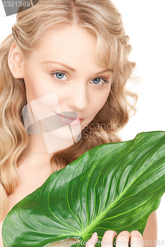 Image of woman with green leaf