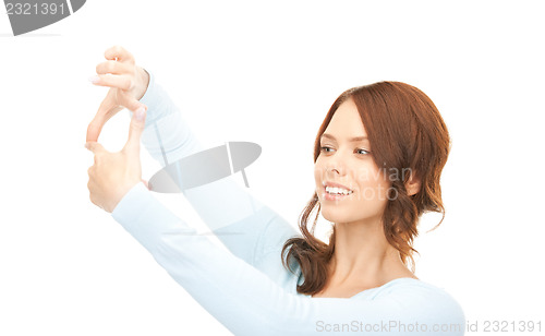 Image of lovely woman creating a frame with fingers