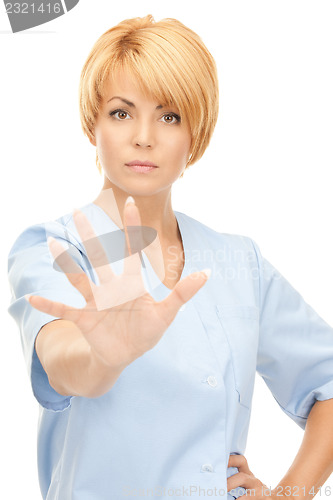 Image of attractive female doctor showing stop gesture