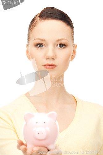 Image of  lovely woman with piggy bank	 