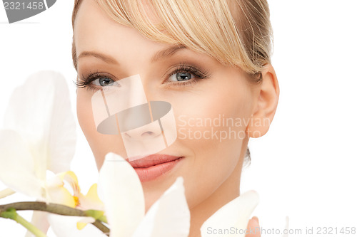 Image of beautiful woman with orchid flower