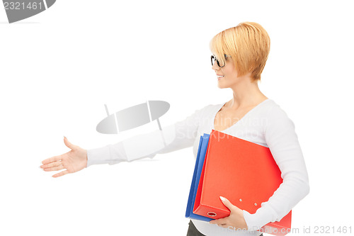 Image of businesswoman with folders ready for handshake