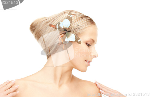 Image of beautiful woman with butterfly in hair