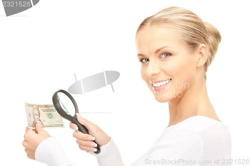 Image of woman with magnifying glass and money