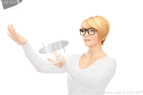 Image of businesswoman working with something imaginary 