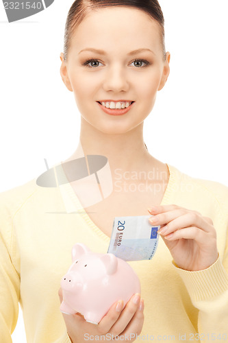 Image of lovely woman with piggy bank 