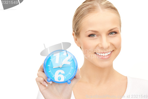 Image of woman holding alarm clock